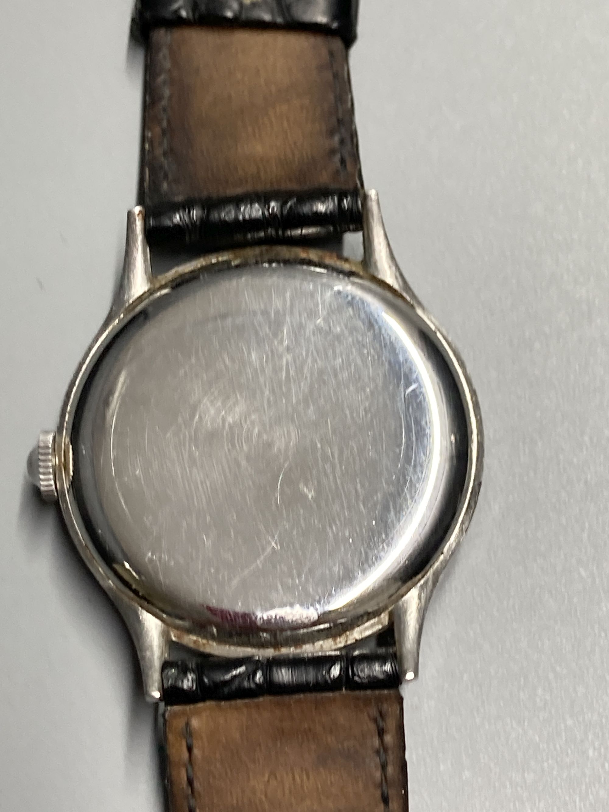 A gentlemans 1940s? stainless steel Omega manual wind wrist watch, with Arabic and dot numerals